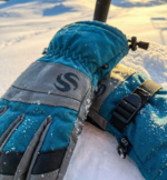 Pair of teal and grey ski gloves with leather knuckle patches and adjustable draw cord cuffs.