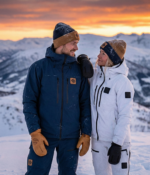 Tan leather winter mittens with reinforced palm grip and pine background
