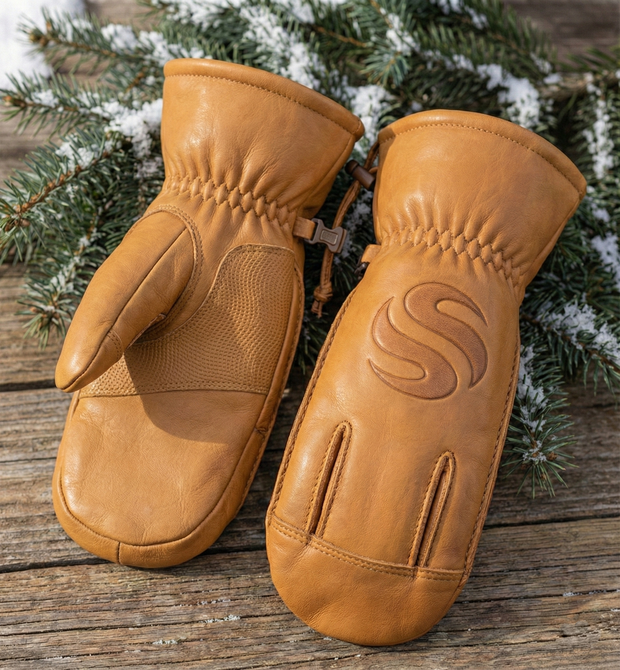 premium-tan-leather-winter-mittens-thermal-insulated-ski-snow-gloves-with-reinforced-grip Tan leather winter mittens with reinforced palm grip and pine background